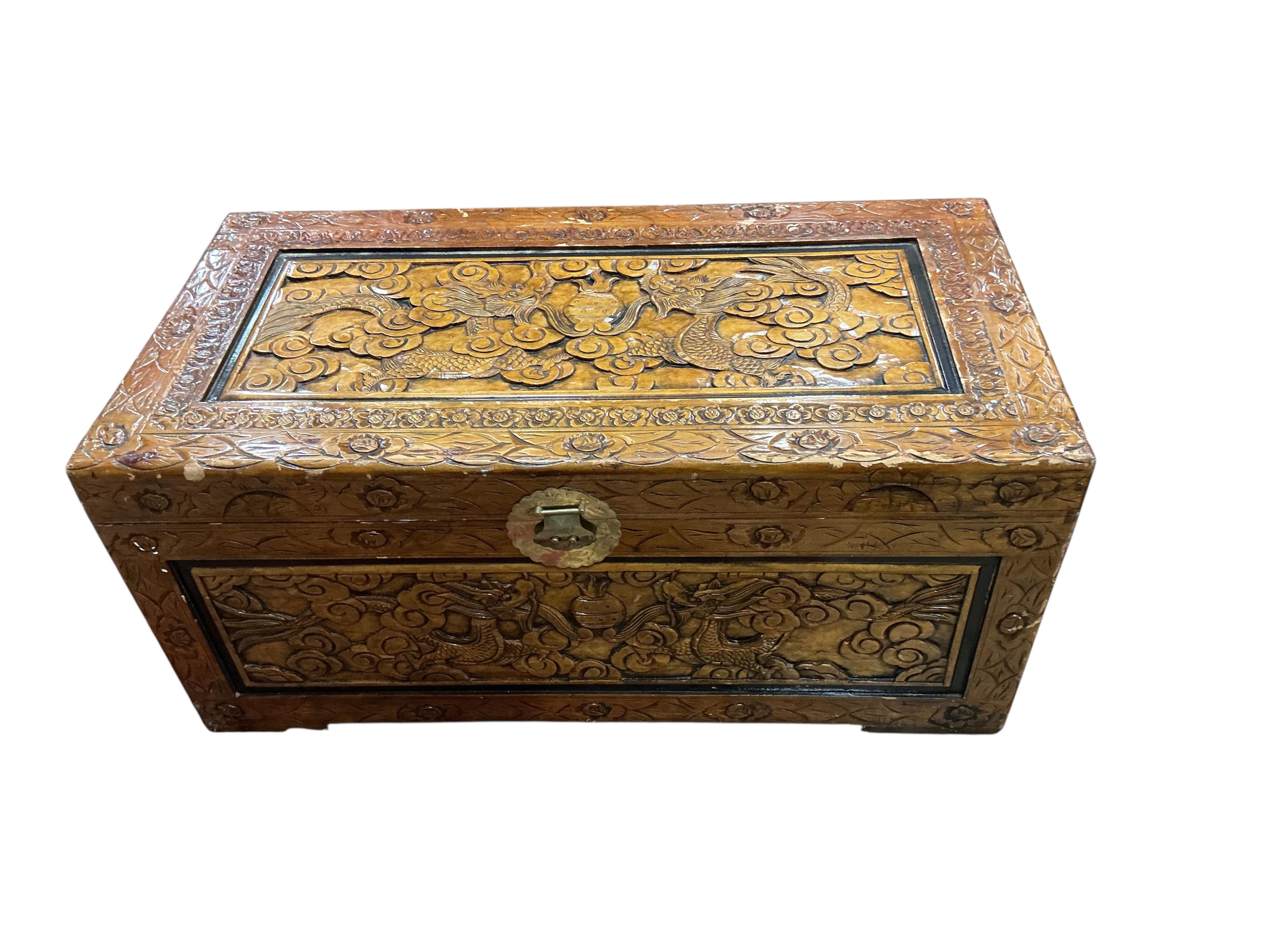 A Chinese carved camphorwood trunk, width 102cm, depth 51cm, height 45cm